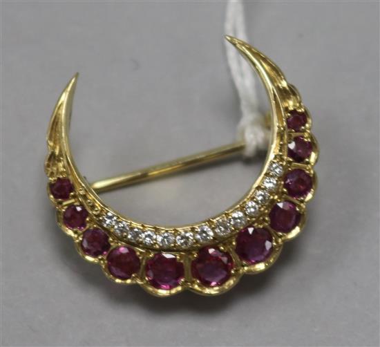 A gold, ruby and diamond crescent brooch